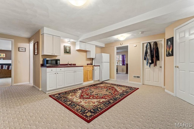 1029 Stonybrook Dr, Ofallon, IL 62269 - kitchen featuring stainless steel microwave, freestanding refrigerator, light colored carpet, a sink, and baseboards