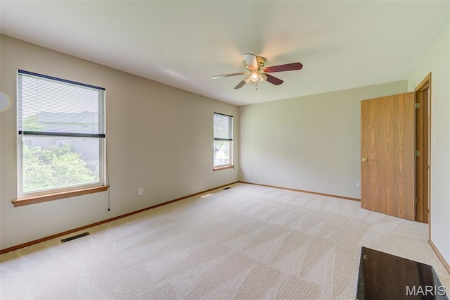 7 Park City Ct, Ofallon, MO 63368 - spare room with a ceiling fan, baseboards, and light carpet