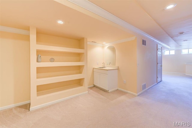 7 Park City Ct, Ofallon, MO 63368 - hall featuring a sink, light carpet, baseboards, crown molding, and built in shelves