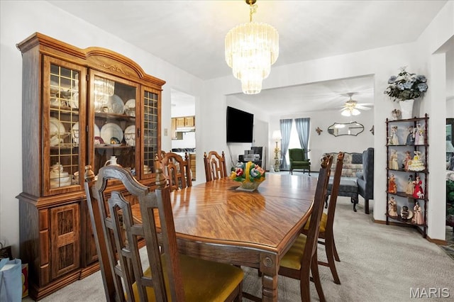 13011 Mystic Bend Ln, Black Jack, MO 63033 - dining space featuring light colored carpet, a chandelier, and ceiling fan