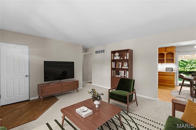 1630 Bobbinray Ave, Florissant, MO 63031 - living room featuring light colored carpet and baseboards