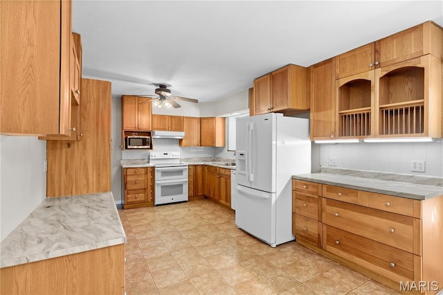 1630 Bobbinray Ave, Florissant, MO 63031 - kitchen with white appliances, under cabinet range hood, ceiling fan, decorative backsplash, and light countertops