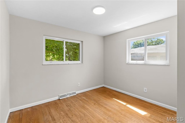 1630 Bobbinray Ave, Florissant, MO 63031 - empty room with healthy amount of natural light, baseboards, and light wood-type flooring