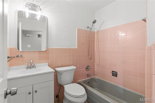 1630 Bobbinray Ave, Florissant, MO 63031 - full bathroom featuring vanity, bathing tub / shower combination, toilet, tile walls, and wainscoting