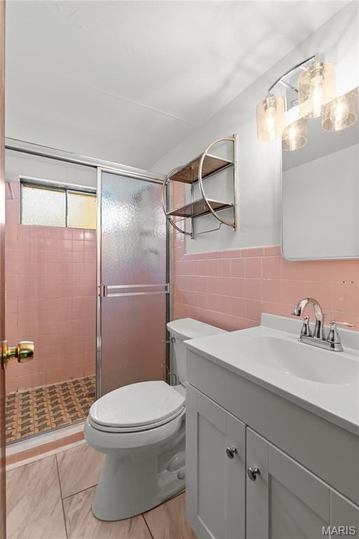 1630 Bobbinray Ave, Florissant, MO 63031 - bathroom with vanity, toilet, tile walls, and a stall shower