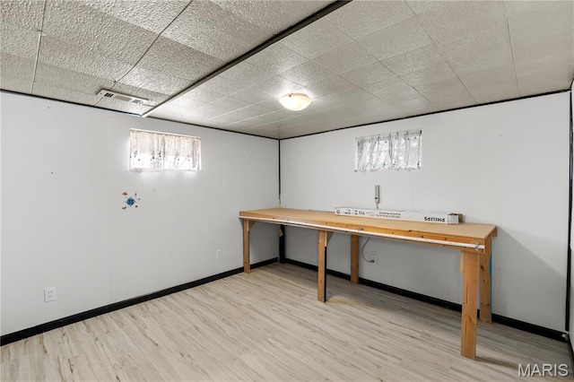 1630 Bobbinray Ave, Florissant, MO 63031 - below grade area with wood finished floors, baseboards, and a paneled ceiling