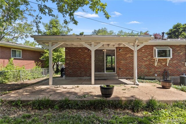 1630 Bobbinray Ave, Florissant, MO 63031 - back of property featuring a patio, brick siding, and central air condition unit