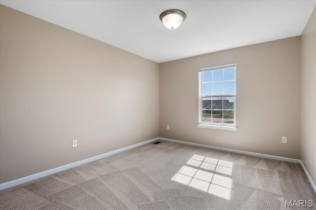 empty room with carpet flooring and baseboards