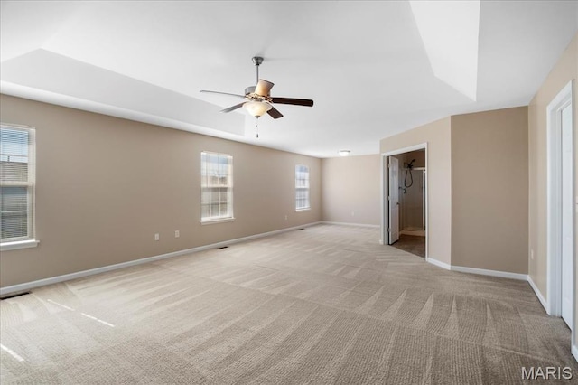 unfurnished bedroom with light colored carpet, baseboards, and ceiling fan