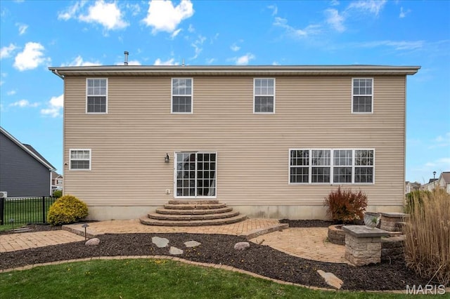 rear view of property with fence and a patio