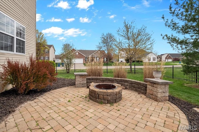view of patio / terrace with a residential view, a fire pit, and fence