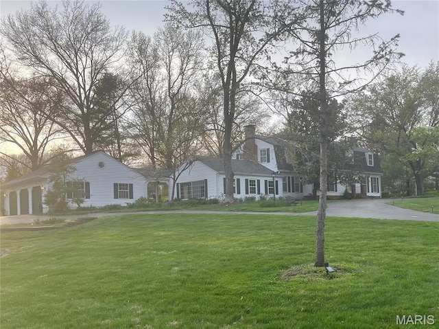 1843 Manor Hill Rd, Saint Louis, MO 63131 - view of front of property with a front lawn, a chimney, and driveway