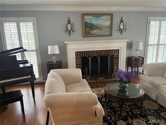 1843 Manor Hill Rd, Saint Louis, MO 63131 - living area featuring a brick fireplace, wood finished floors, and crown molding