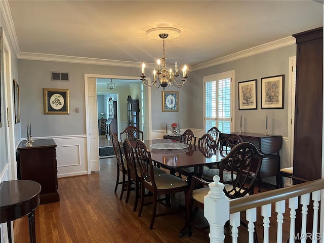 1843 Manor Hill Rd, Saint Louis, MO 63131 - dining space with a chandelier, dark wood-type flooring, a wainscoted wall, ornamental molding, and a decorative wall