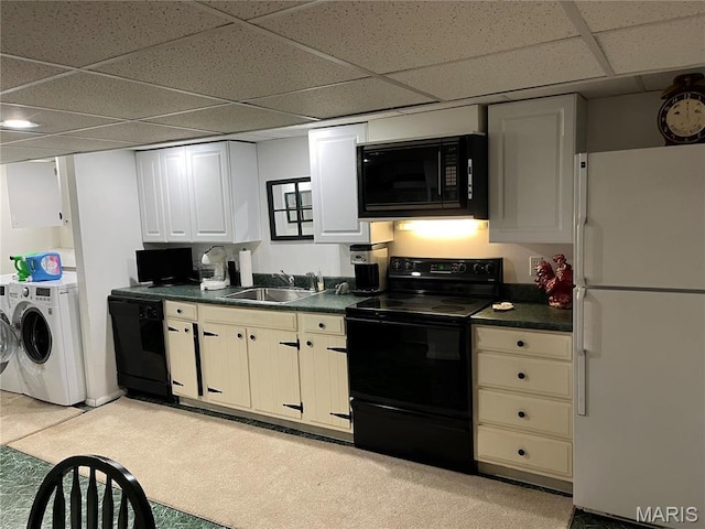1843 Manor Hill Rd, Saint Louis, MO 63131 - kitchen with black appliances, independent washer and dryer, a sink, dark countertops, and a drop ceiling