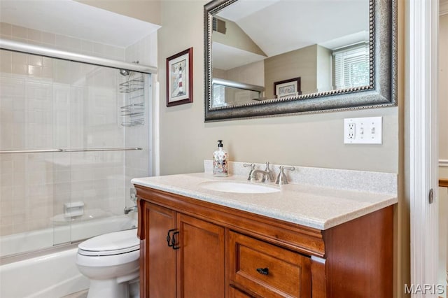 1843 Manor Hill Rd, Saint Louis, MO 63131 - full bathroom featuring vanity, toilet, bath / shower combo with glass door, and vaulted ceiling