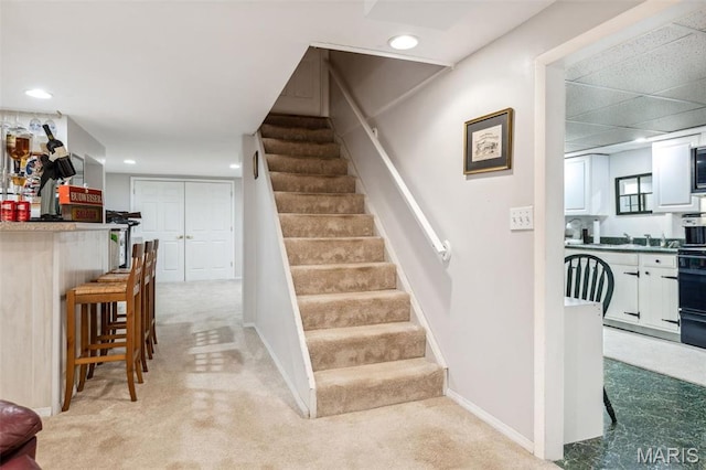 1843 Manor Hill Rd, Saint Louis, MO 63131 - stairway featuring recessed lighting, baseboards, a dry bar, and carpet floors