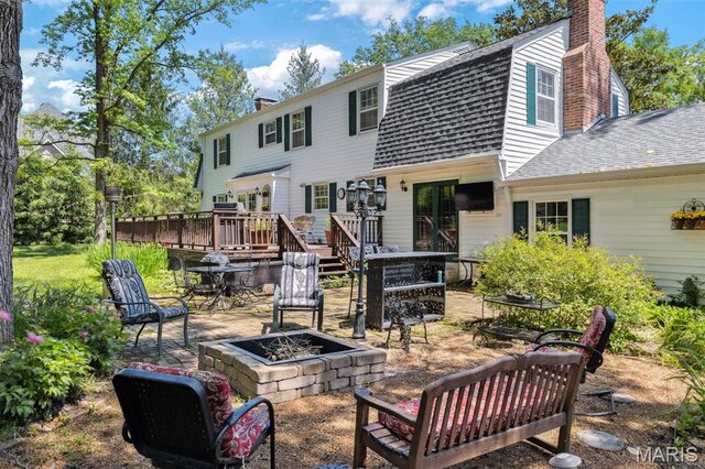 1843 Manor Hill Rd, Saint Louis, MO 63131 - rear view of house with a fire pit, a shingled roof, a gambrel roof, a chimney, and a deck