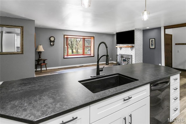 26152 Beltrees Rd, Dow, IL 62022 - kitchen featuring dark countertops, a brick fireplace, white cabinetry, and black dishwasher