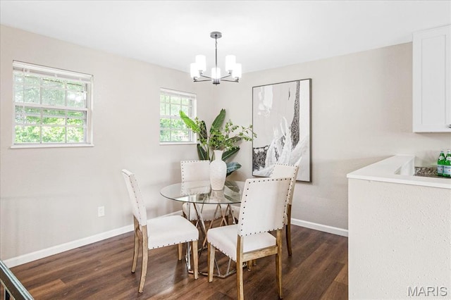 2145 Glenoro Dr, Florissant, MO 63033 - dining room with a chandelier, dark wood-style floors, and baseboards