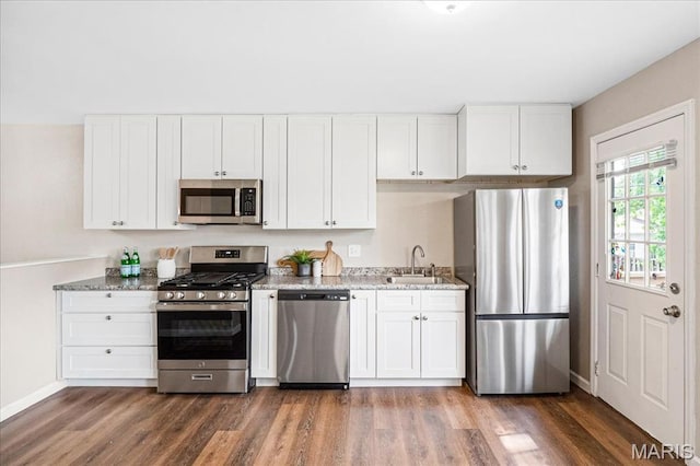 2145 Glenoro Dr, Florissant, MO 63033 - kitchen with appliances with stainless steel finishes, a sink, wood finished floors, and white cabinets