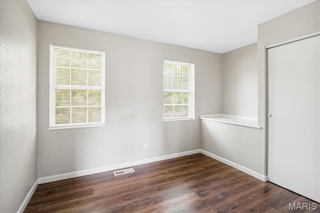 2145 Glenoro Dr, Florissant, MO 63033 - unfurnished room featuring dark wood finished floors and baseboards