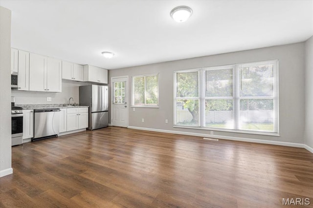2145 Glenoro Dr, Florissant, MO 63033 - kitchen with appliances with stainless steel finishes, a sink, dark wood-type flooring, and baseboards