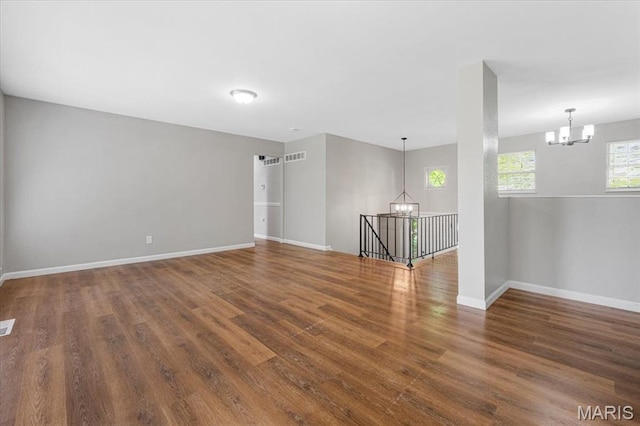 2145 Glenoro Dr, Florissant, MO 63033 - unfurnished room with a chandelier, baseboards, and wood finished floors