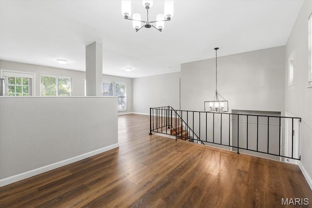 2145 Glenoro Dr, Florissant, MO 63033 - unfurnished room featuring a chandelier, wood finished floors, baseboards, and healthy amount of natural light