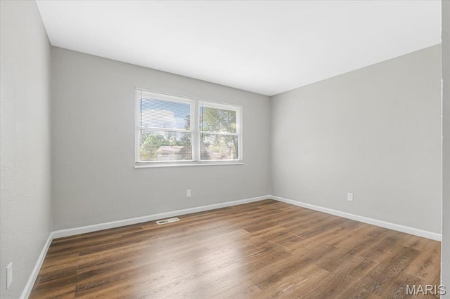 2145 Glenoro Dr, Florissant, MO 63033 - spare room featuring wood finished floors and baseboards