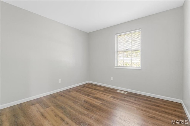 2145 Glenoro Dr, Florissant, MO 63033 - unfurnished room featuring baseboards and wood finished floors