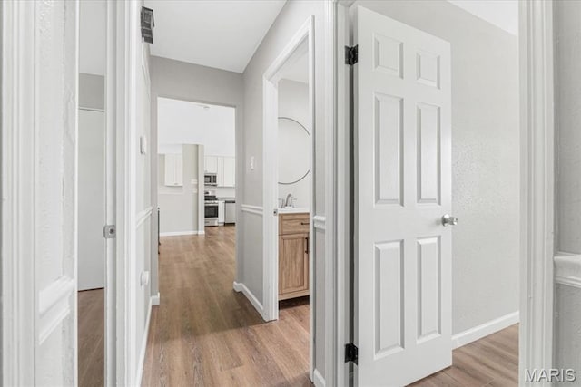 2145 Glenoro Dr, Florissant, MO 63033 - corridor featuring wood finished floors and baseboards