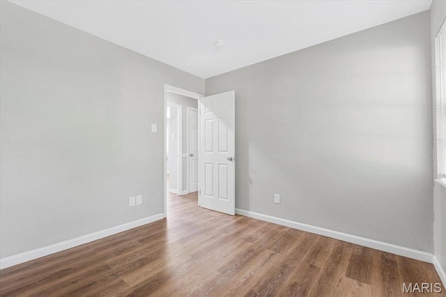 2145 Glenoro Dr, Florissant, MO 63033 - empty room with wood finished floors and baseboards