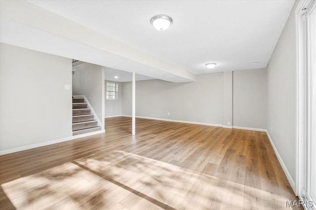 2145 Glenoro Dr, Florissant, MO 63033 - below grade area with wood finished floors, baseboards, and stairway