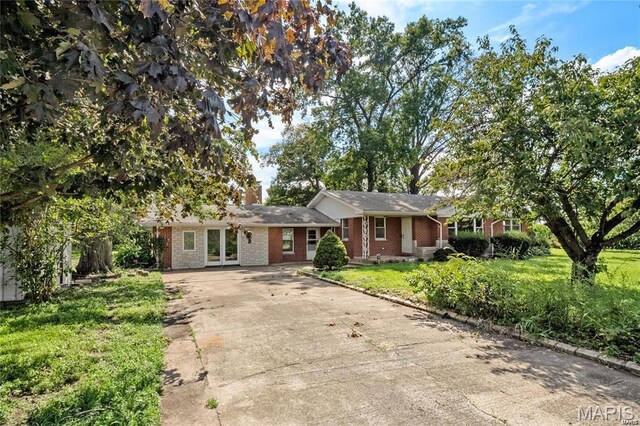 9506 B Rd, Valmeyer, IL 62295 - ranch-style house with concrete driveway, brick siding, a front yard, and a chimney