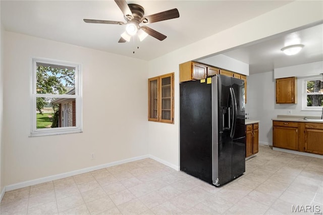 9506 B Rd, Valmeyer, IL 62295 - kitchen with black refrigerator with ice dispenser, brown cabinets, ceiling fan, light countertops, and baseboards