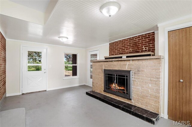 9506 B Rd, Valmeyer, IL 62295 - unfurnished living room with finished concrete floors, a brick fireplace, baseboards, and crown molding