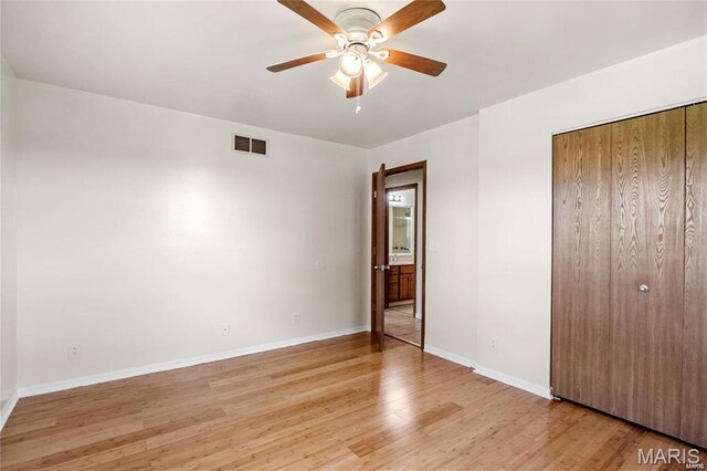 9506 B Rd, Valmeyer, IL 62295 - unfurnished bedroom featuring light wood-style flooring, baseboards, a closet, and ceiling fan