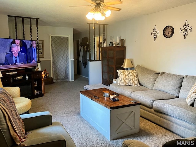 carpeted living room featuring a ceiling fan