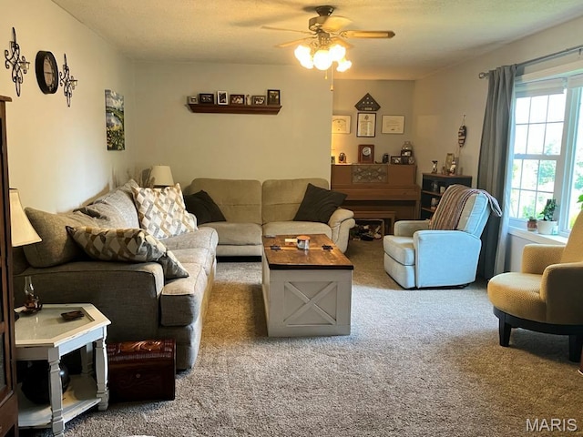 living area with carpet and ceiling fan