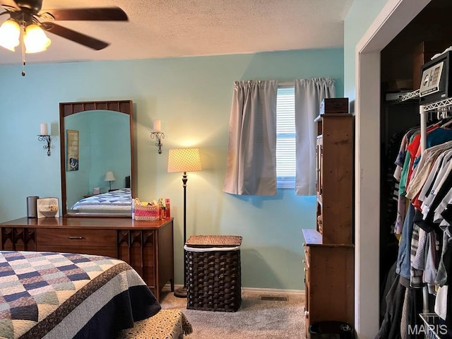 bedroom with carpet, baseboards, and a ceiling fan
