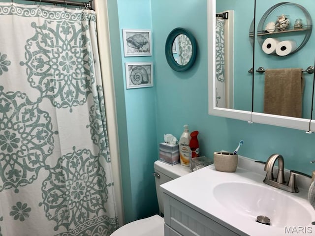 bathroom featuring toilet and vanity