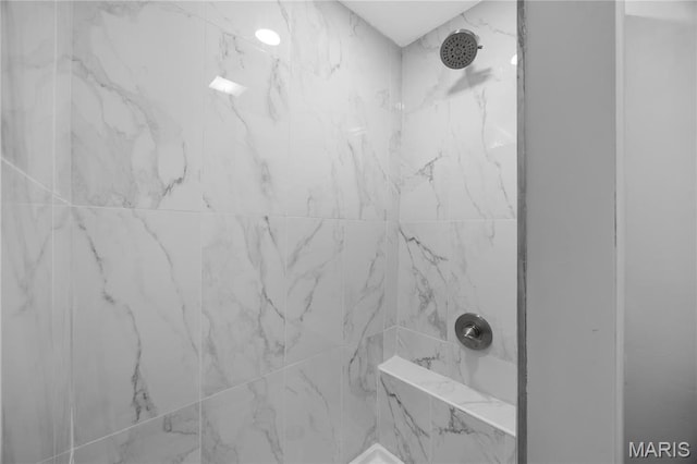 bathroom view of a marble finish shower