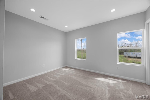 carpeted empty room featuring baseboards and recessed lighting