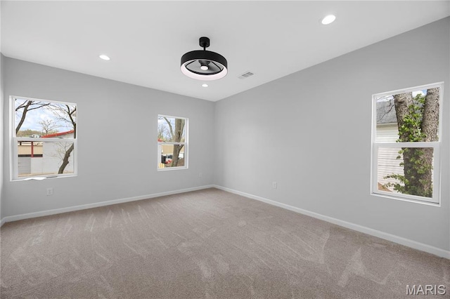 carpeted spare room with baseboards and recessed lighting