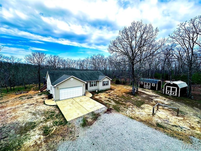 127 Kehner Rd, Steelville, MO 65565 - ranch-style home with concrete driveway, a garage, a shed, and an outbuilding