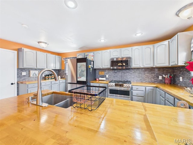 127 Kehner Rd, Steelville, MO 65565 - kitchen featuring butcher block countertops, stainless steel appliances, a sink, decorative backsplash, and recessed lighting