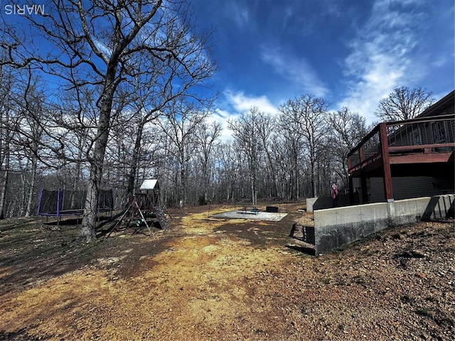 127 Kehner Rd, Steelville, MO 65565 - view of yard with a trampoline, a wooden deck, and a playground