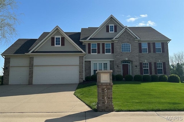 view of front facade featuring a front yard, driveway, and an attached garage