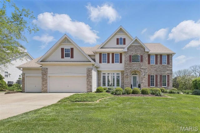 view of front of home with concrete driveway, a front yard, a garage, and brick siding